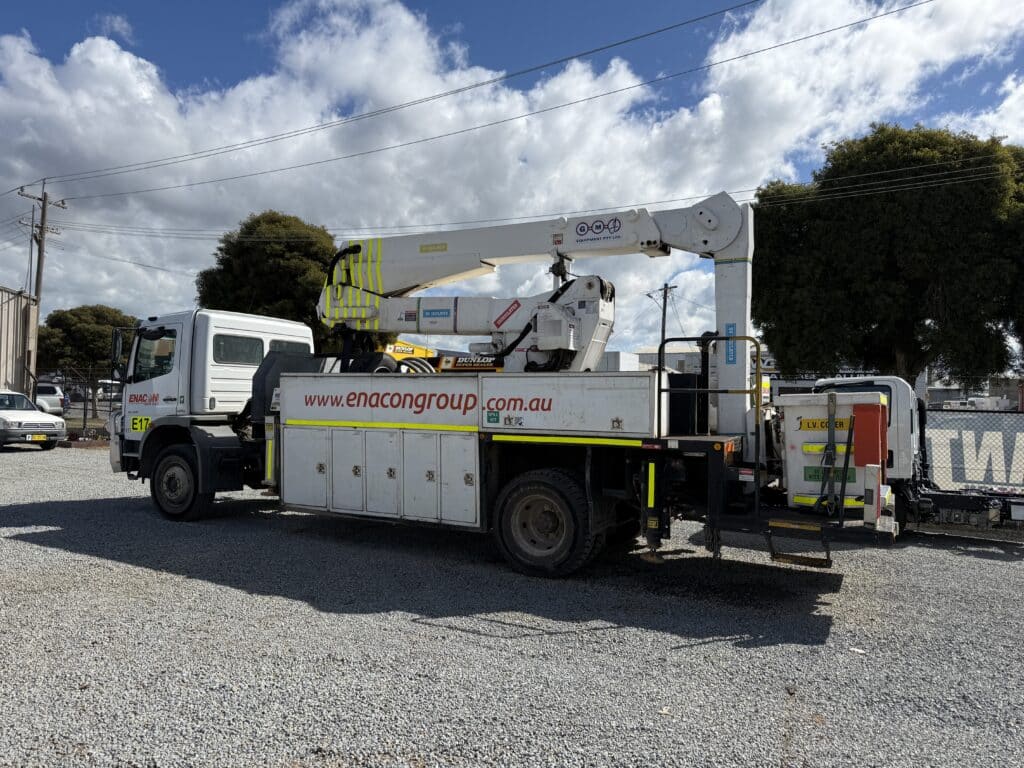Truck with elevated working platform installed.